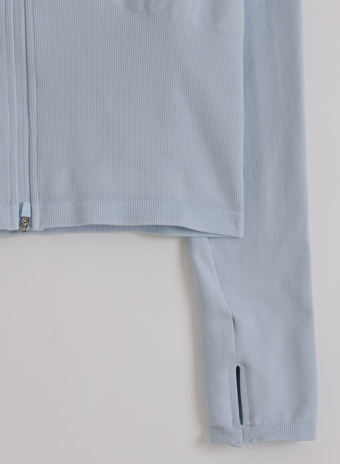 Light blue Aura Shape Seamless Zip Jacket featuring a ribbed hem and long sleeve with a thumbhole.