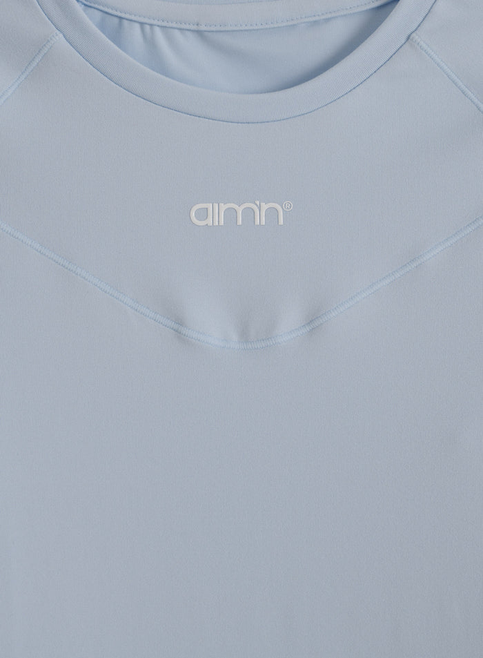 Light blue Soft Basic Long Sleeve top with a round neckline and printed aim'n logo on the chest.