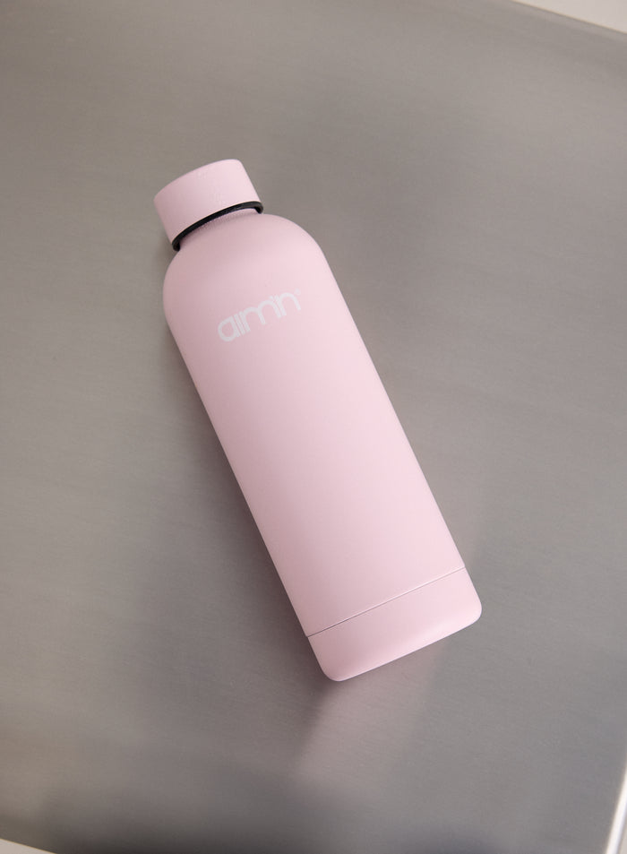 A matte Ballerina pink Core Water Bottle with a white aim'n logo