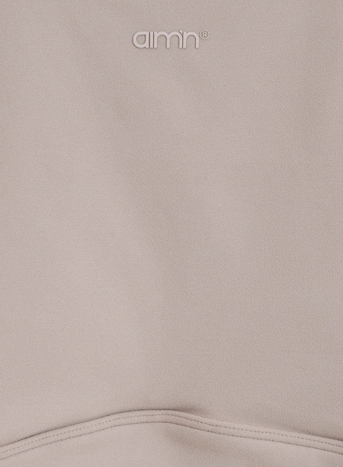 Dark Clay Sense Sports Bra detail showing the soft brushed fabric and printed aim'n logo.