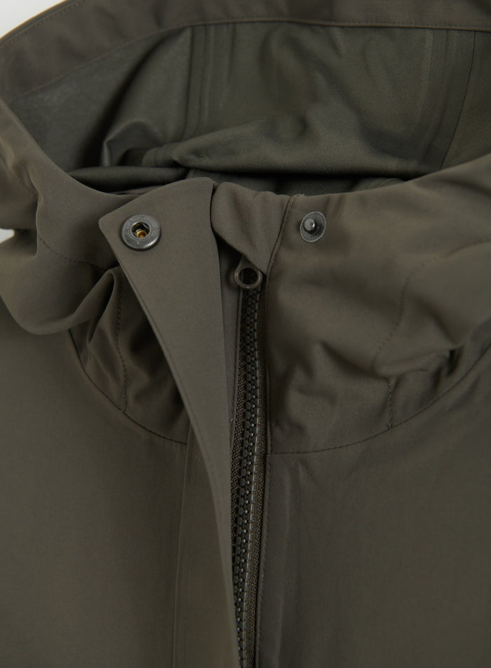 Close-up of the zipper and snap button details on the Dark Ivy Waterproof Oversized Anorak