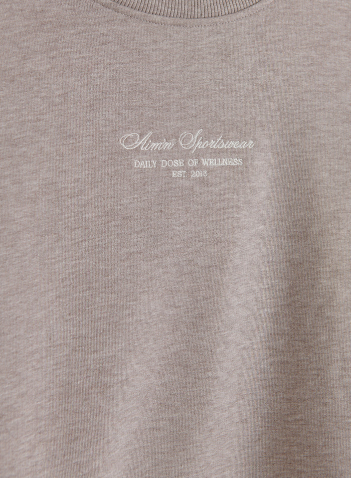 Espresso Melange jersey sweatshirt featuring white aim'n script embroidery across the chest.