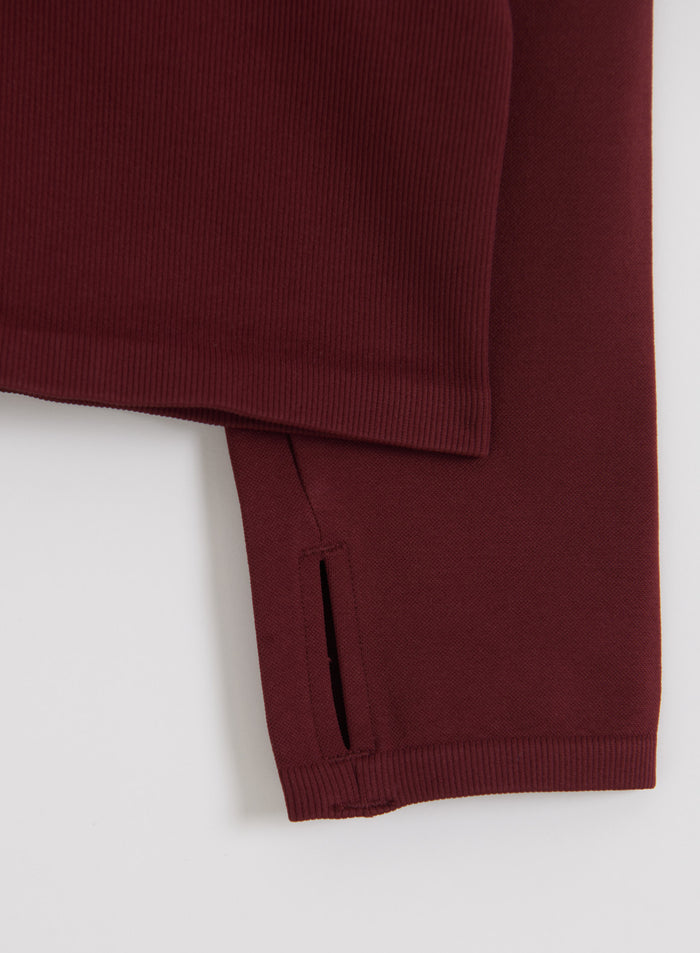 Merlot Shape Seamless Zip Jacket sleeve featuring a thumbhole and ribbed cuff by aim'n.