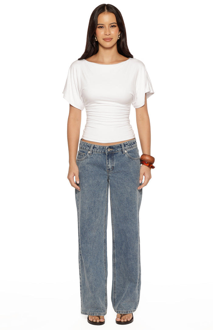 White jersey top with a boat neckline, short flutter sleeves, and a ruched waist detail