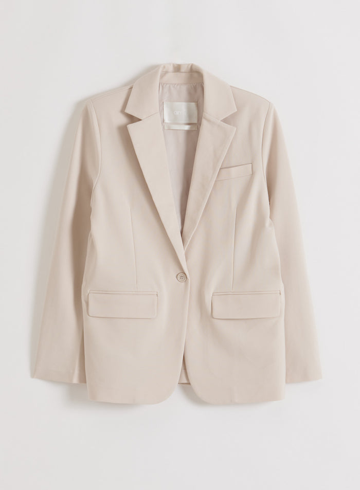 Flat lay of a sand-colored Luxe Relaxed Blazer
