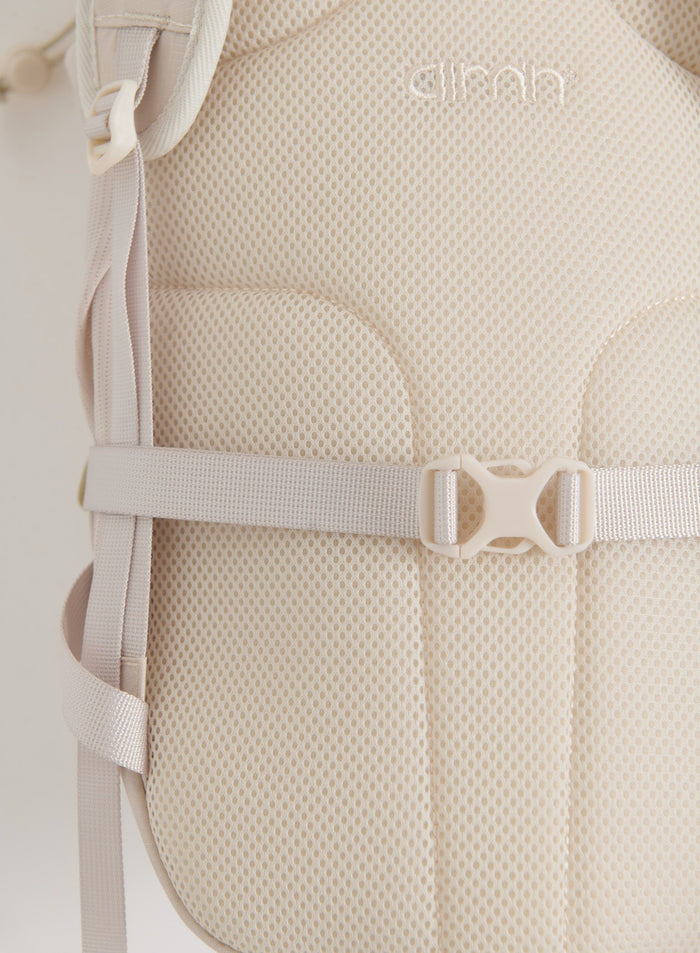 Close-up of the sand Outdoor Daypack showing its breathable mesh back panel, shoulder straps, and chest buckle