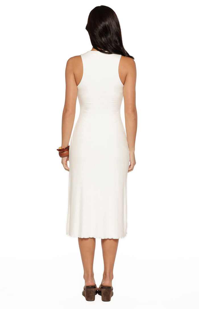Rear view of a white sleeveless midi dress with a high round back and a fitted silhouette in a soft knit