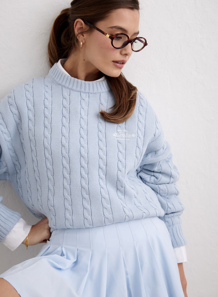 Light blue Aura Club Cable Knit Sweater by aim'n styled over a white collared shirt. [M-174cm]