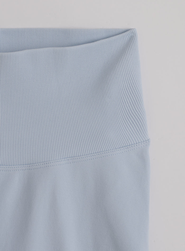 Close-up of the high, ribbed waistband on light blue Aura Shape Seamless Hotpants by aim'n.
