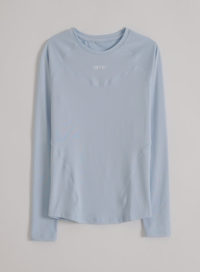 Light blue aim'n Soft Basic Long Sleeve featuring raglan sleeves and a soft second skin feel. [S-174cm]