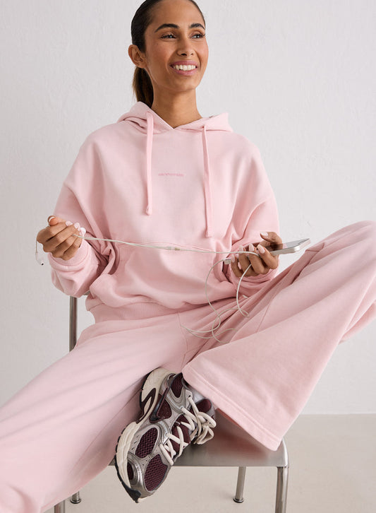 A woman sitting on a chair wearing a pink Ballerina Apparel Chunky Terry Hood by aim'n [S-170cm]