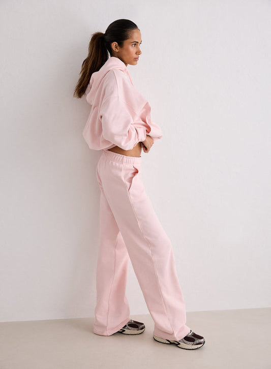 A woman standing in profile wearing pink Ballerina Chunky Terry Sweatpants and a matching hoodie [S-170cm]