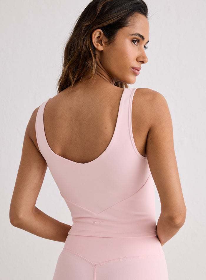 Rear view of a woman wearing a light pink Sense Bralette by aim'n, highlighting the deep V-cut back [XS-170cm]