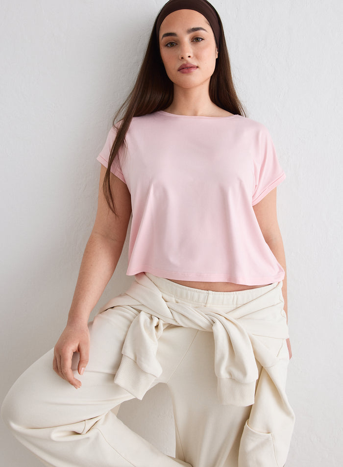 A woman wearing a pink Soft Basic Roll Sleeve Top by aim'n with a boxy fit and rolled sleeves [L-174cm]