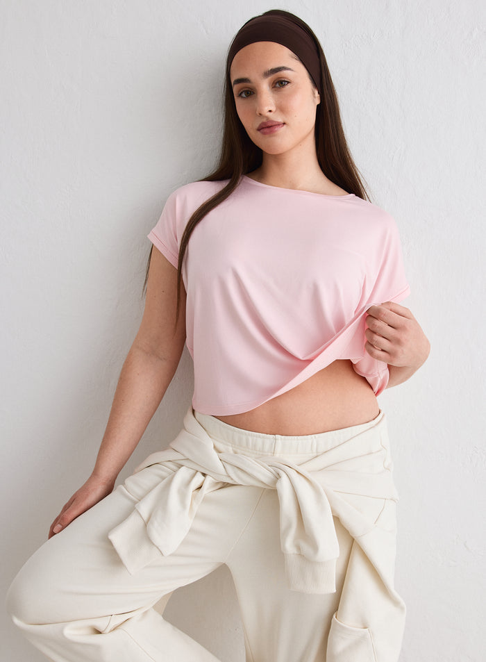 A woman wearing a pink Ballerina Soft Basic Roll Sleeve Top from aim'n [L-174cm]