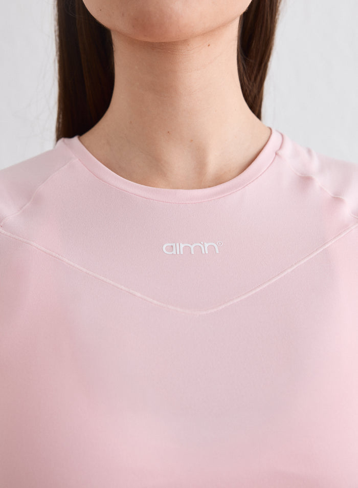 Close-up of the round neckline and printed aim'n logo on the pink Ballerina Soft Basic Short Sleeve [L-174cm]