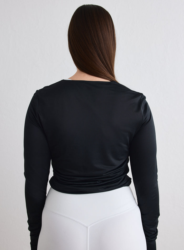 Back view of a model wearing a Black Luminous Draped Long Sleeve from aim'n [L-174cm]