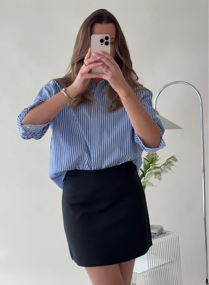 Woman taking a mirror selfie wearing a Black Luxe Mini Skort by aim'n [38-175cm]