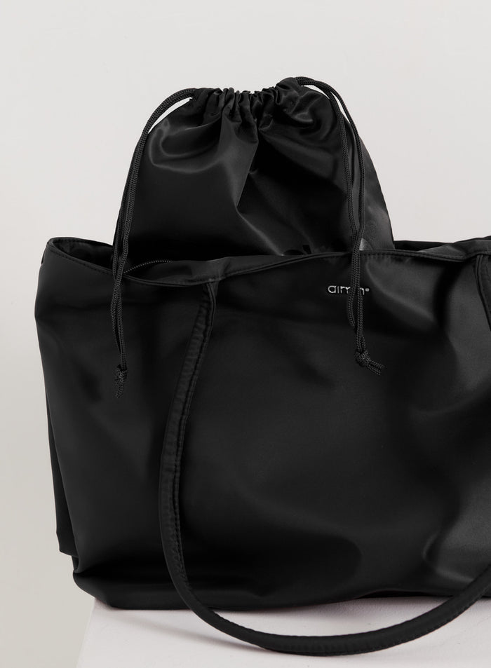 Black aim'n Nylon Tote Bag with a smooth finish and internal drawstring pouch.