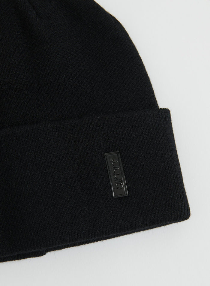 Close-up of a black knitted Outdoor Logo Beanie with a folded cuff and aim'n logo patch