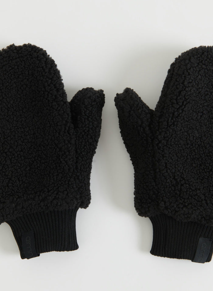 Pair of black pile mittens with textured fleece and ribbed cuffs shown in a flat lay