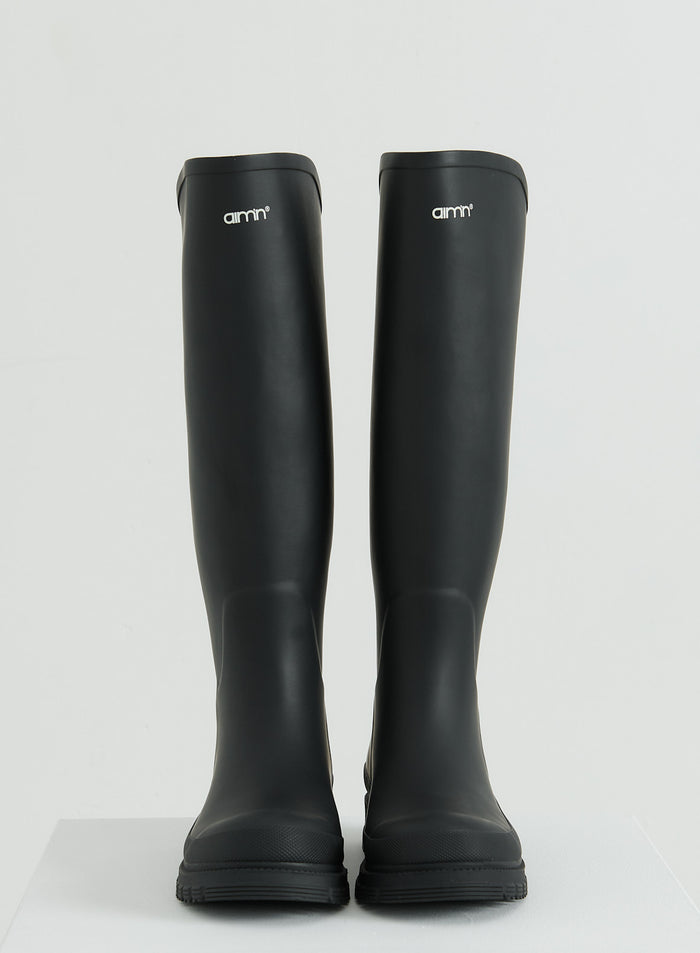 Tall black rain boots with the aim'n logo