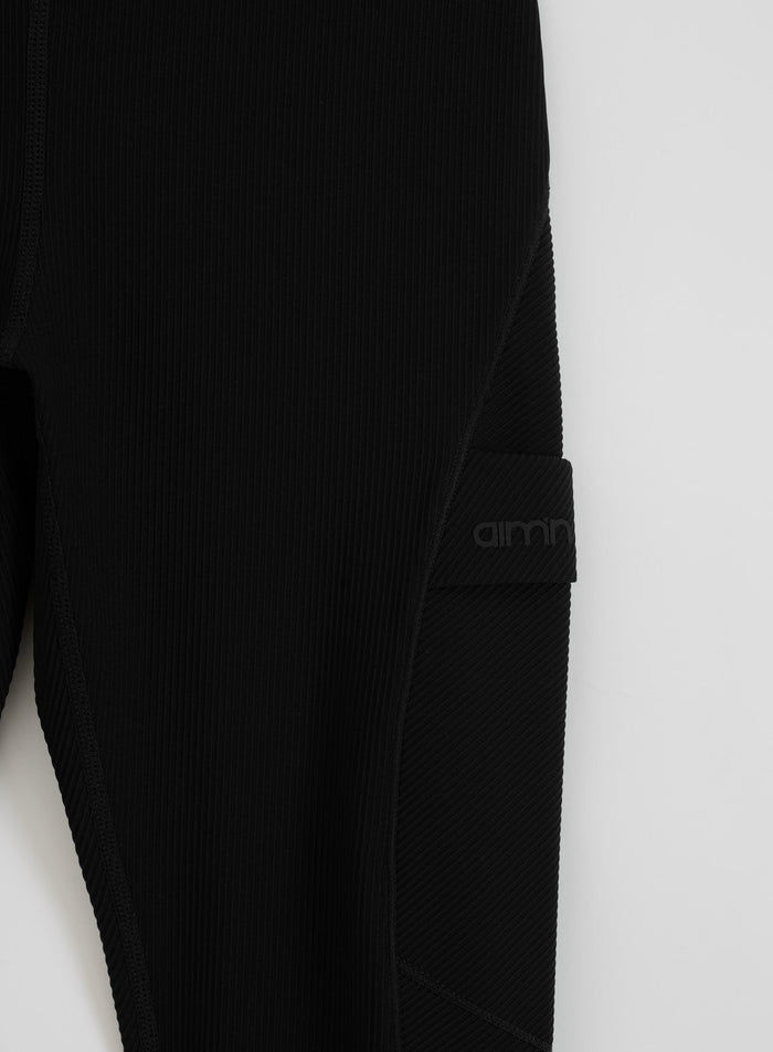 Black Ribbed Performance Pocket Tights by aim'n featuring a functional side pocket and logo.