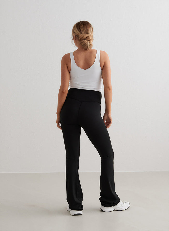 Black aim'n Sense Maternity Flare Tights featuring a high waistband and flared legs, shown from behind.