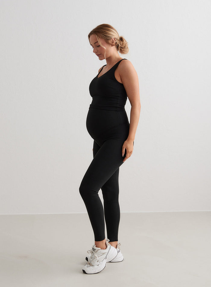 Black aim'n Sense Maternity Petite Tights on a pregnant woman, offering a second skin fit and squat proof finish.