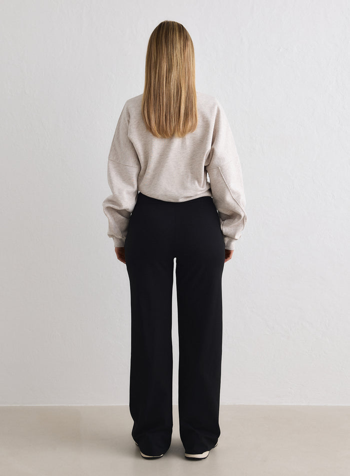 Rear view of black aim'n Sense Tall Pants featuring a relaxed, wide-leg fit and high waist. [M-170cm]