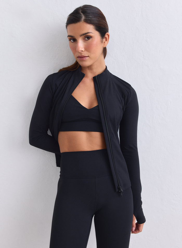 Black aim'n Sense Zip Jacket made from peachy soft fabric, featuring thumbholes and a two-way zip. [XS-165cm]