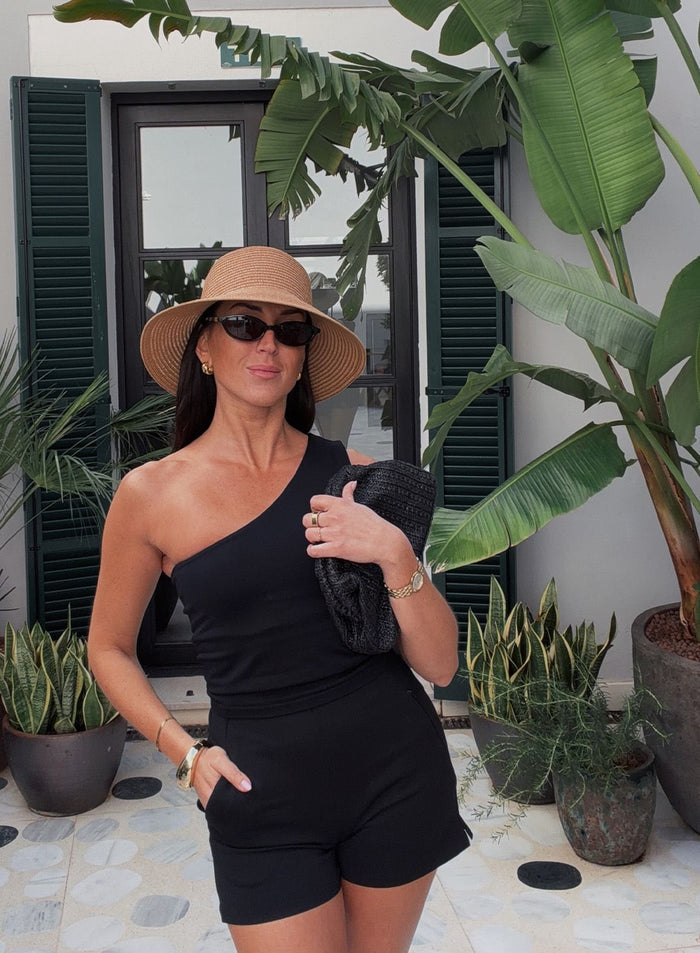 Black aim'n Shape Seamless One Shoulder Bralette worn by a woman with a straw hat in a sunny outdoor setting.