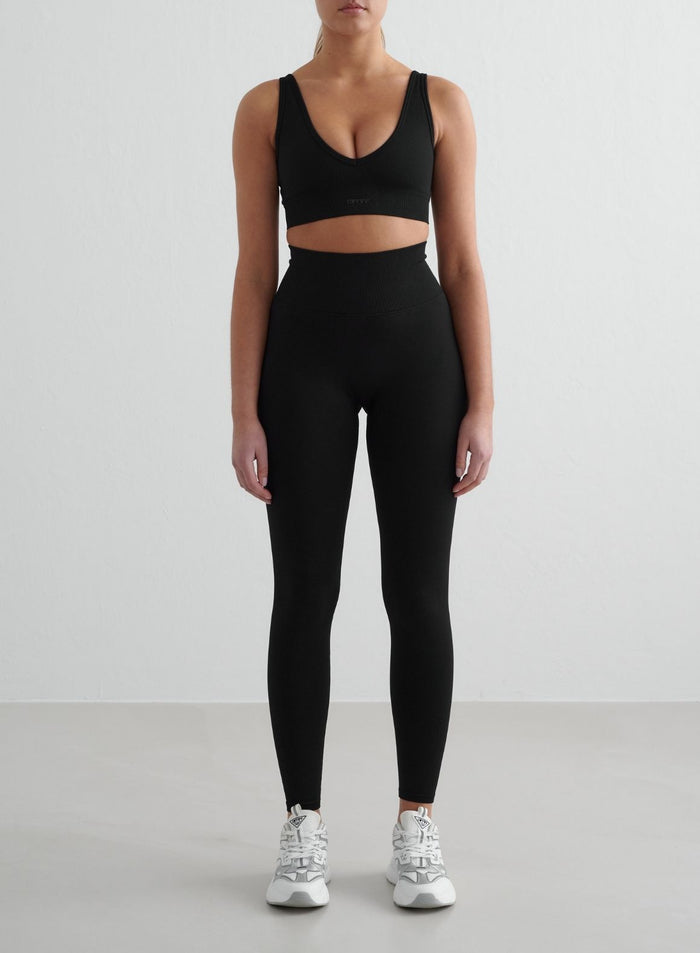 Front view of a model wearing black Shape Seamless Tights from aim'n [S - 175 cm]