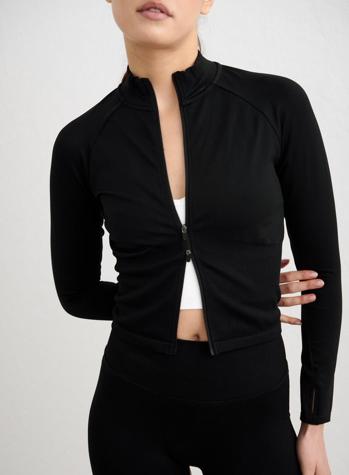 Black Shape Seamless Zip Jacket with a second skin feel, thumbholes, and full-length zip by aim'n. [S-178cm]