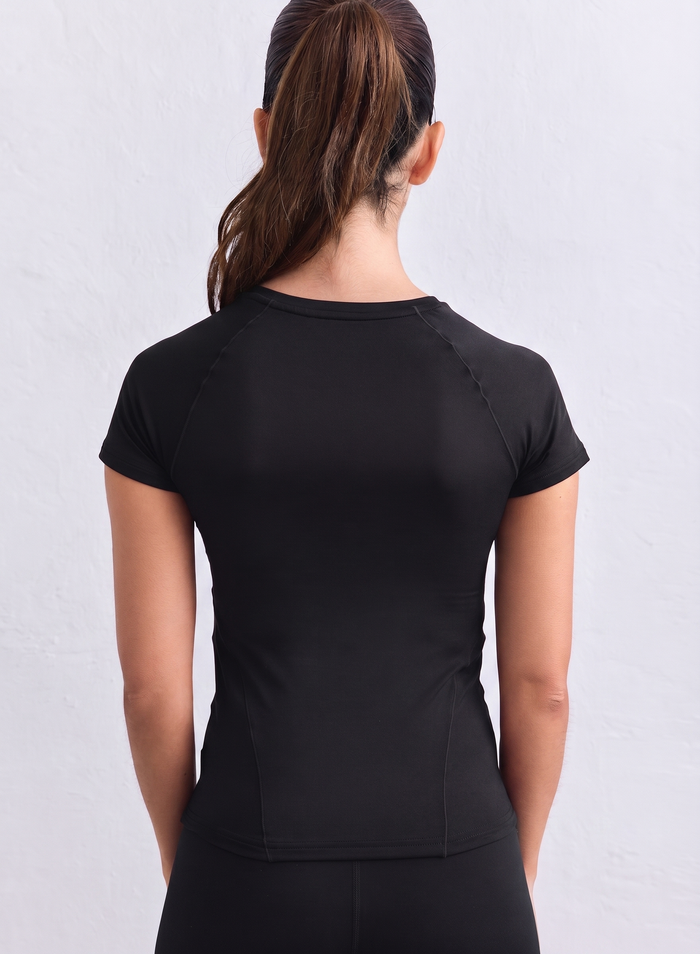 Black aim'n Soft Basic Short Sleeve top featuring raglan sleeves and a round neckline, shown from the back.