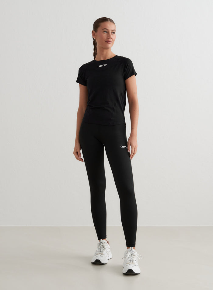 Black Soft Basic Short Sleeve t-shirt with a second skin feel, styled with aim'n leggings and sneakers.