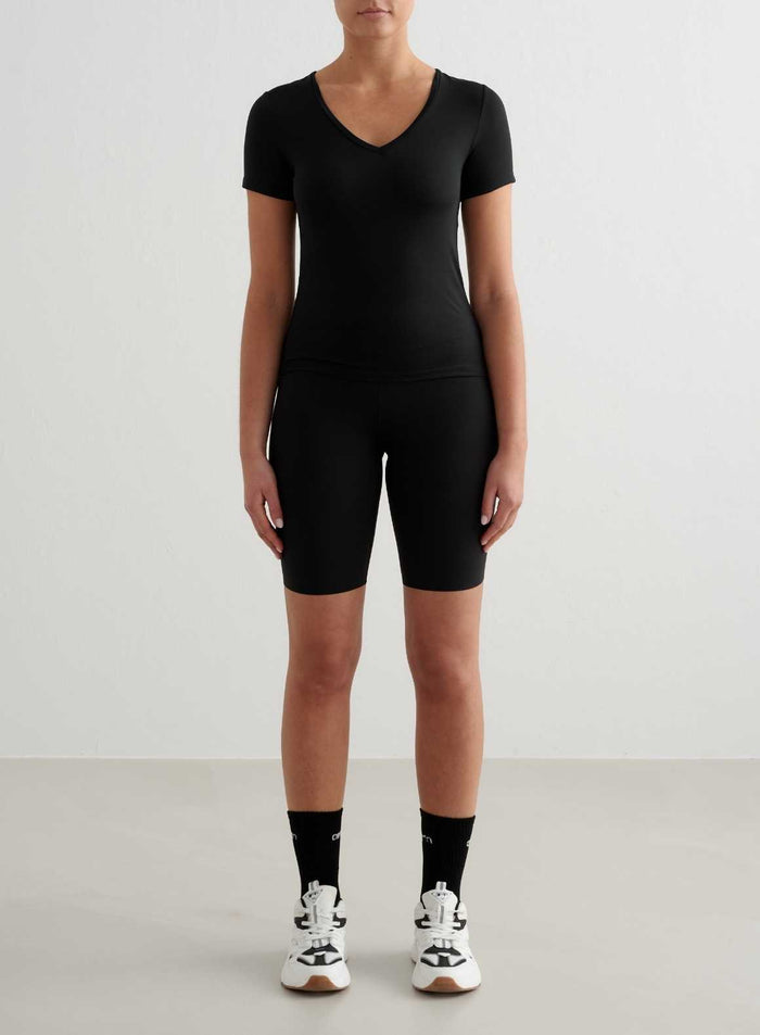 Black Soft Basic V-neck Short Sleeve top by aim'n styled with matching biker shorts for a sleek workout look.
