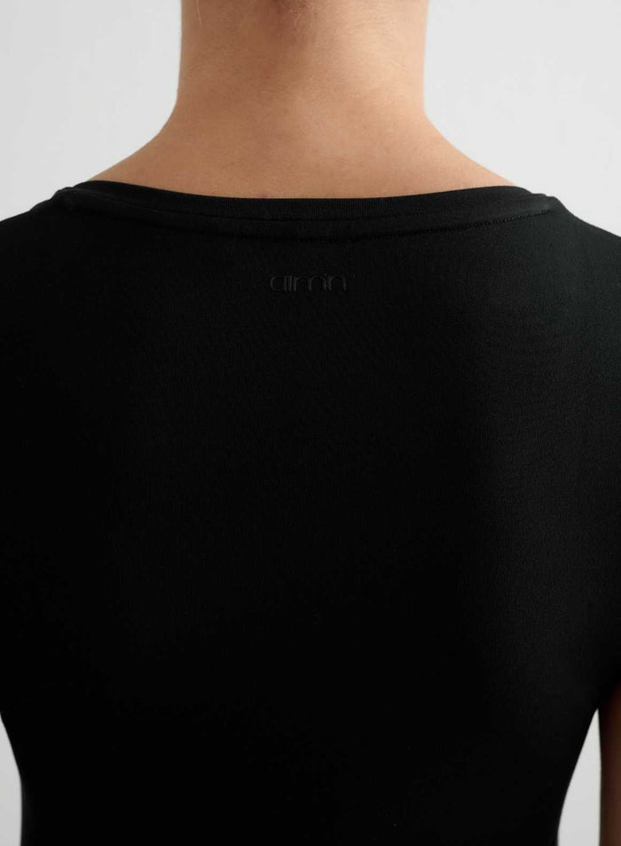 Back view of a black Soft Basic V-neck Short Sleeve in ultra-soft fabric with a tonal aim'n logo.