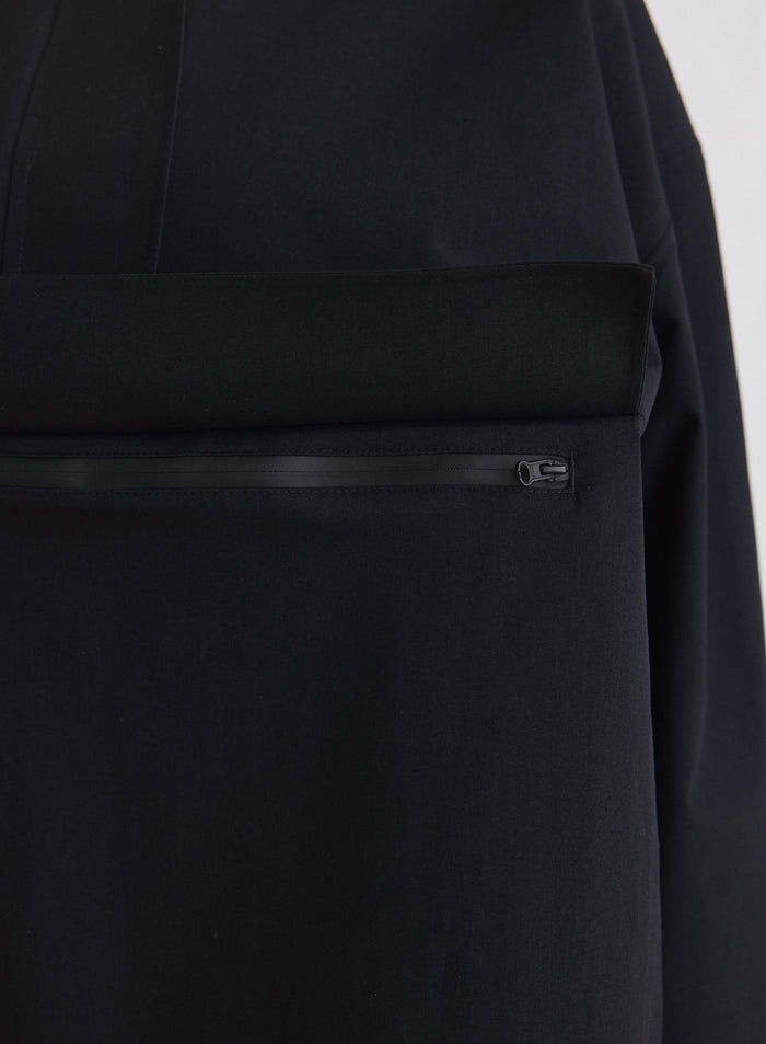 Close-up of the zippered chest pocket on the Black Waterproof Oversized Anorak [M-174cm]
