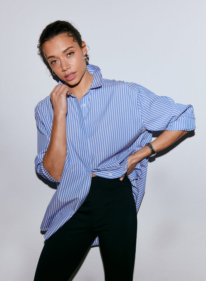 Model wearing an oversized blue stripe poplin shirt with black trousers [M-170cm]