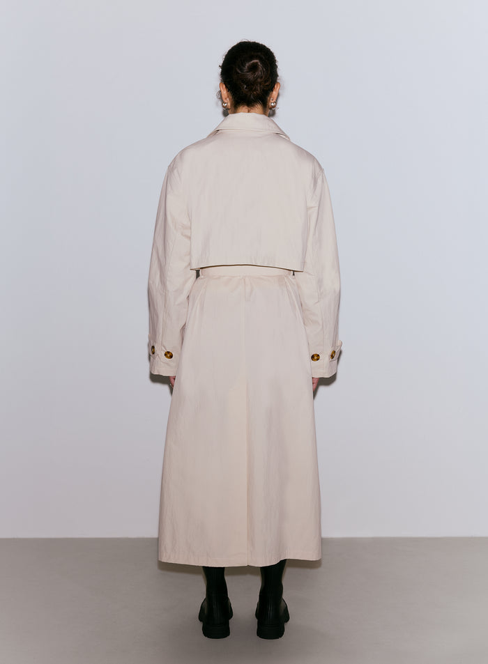Woman from behind wearing a cafe au lait Femme Trenchcoat and dark boots [M-170cm]