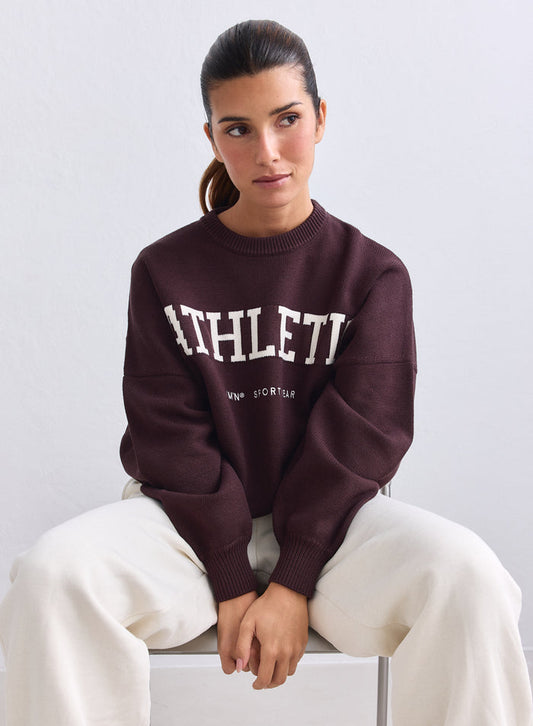 Chocolate aim'n Athletic Knit Sweatshirt with white lettering, styled with cream trousers. [S-165cm]