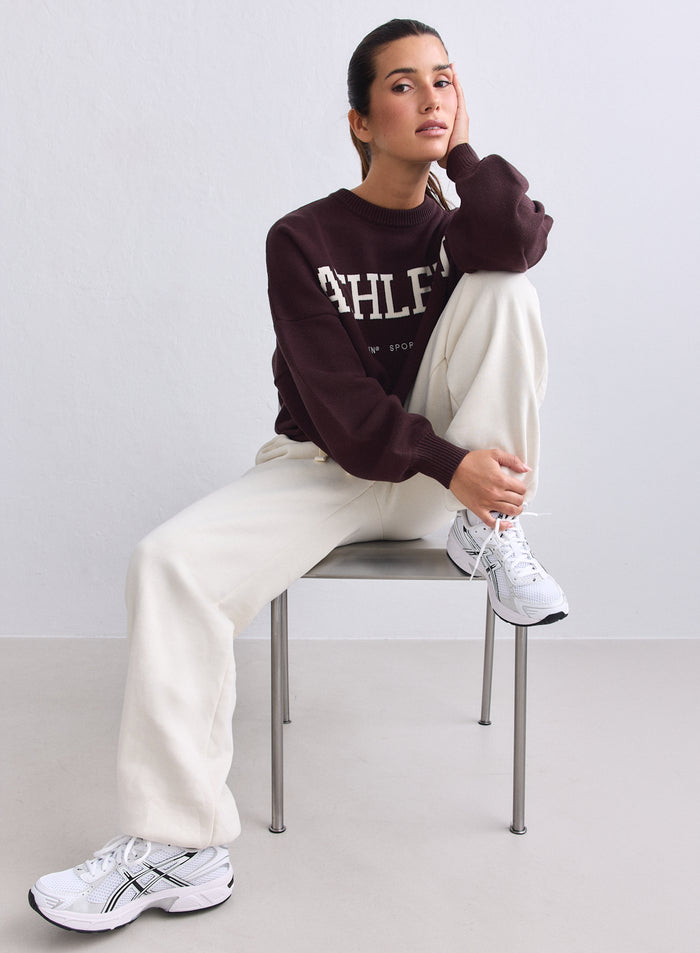 Chocolate Athletic Knit Sweatshirt with white lettering by aim'n, worn by a seated model. [S-165cm]