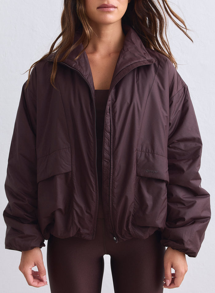 Oversized chocolate brown aim'n Cloud Jacket featuring a high collar and large front pockets. [S-165cm]