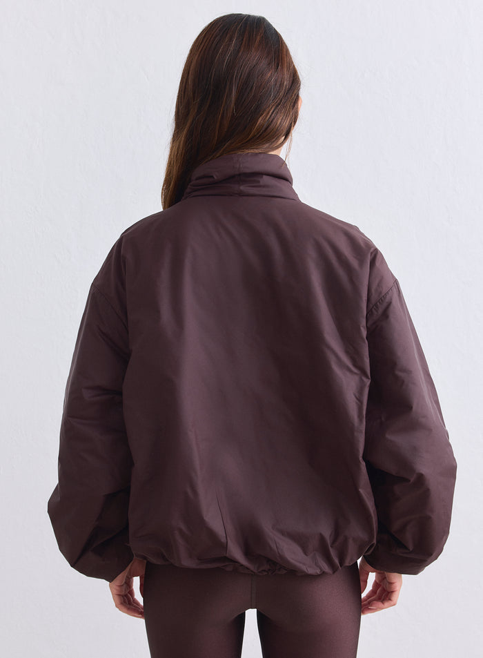 Chocolate brown puffer Cloud Jacket by aim'n shown from the back in an oversized fit. [S-165cm]