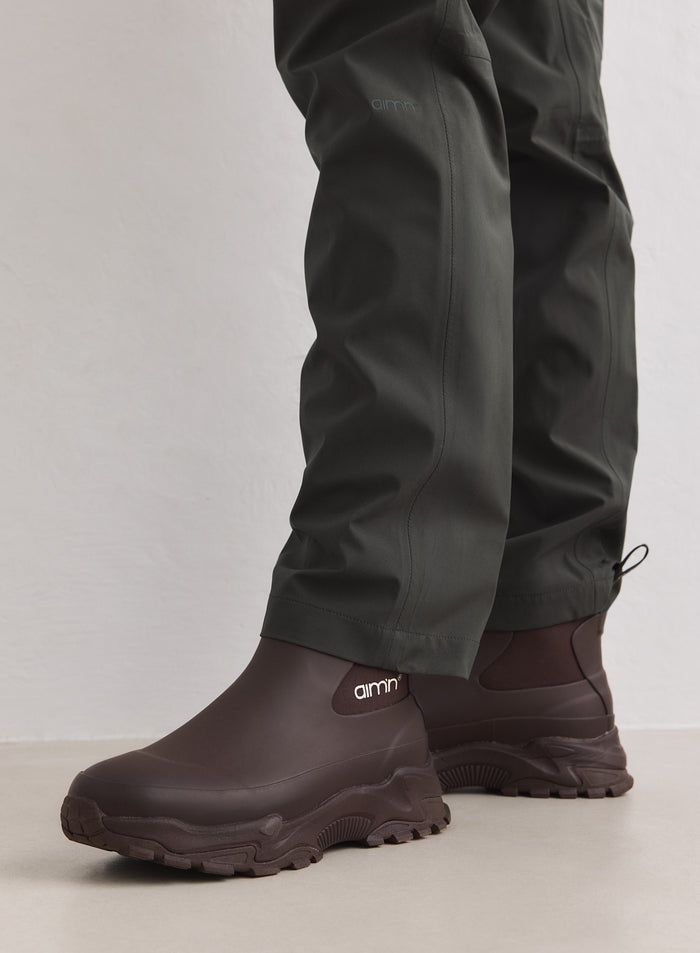 Chocolate Fusion Rain Boots featuring a chunky sneaker outsole and white aim'n logo on a rubber upper.