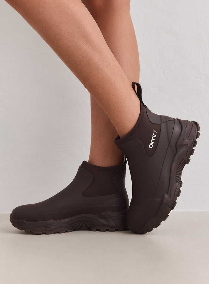 Chocolate Fusion Rain Boots featuring a waterproof rubber upper, chunky sneaker outsole, and aim'n logo.