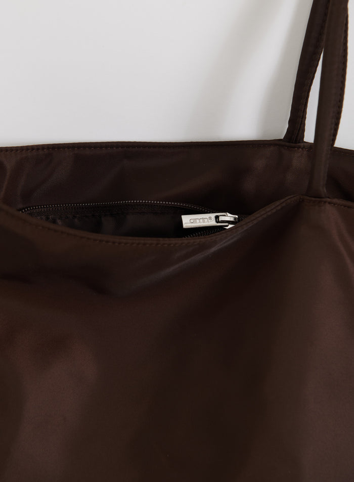 Chocolate brown nylon weekend bag by aim'n showing the interior pocket and silver logo zipper detail.