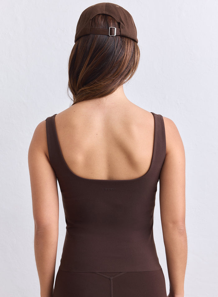 Chocolate brown aim'n Sense Singlet featuring a deep scoop back and wide straps. [S-165cm]