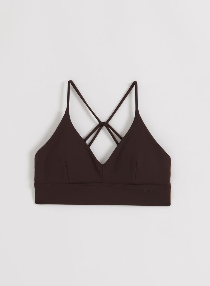 Chocolate Sense Strap Bra by aim'n with a V-neck and thin decorative back straps, flatlay view.